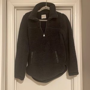 Dark grey faux fur pull over with faux leather accents.